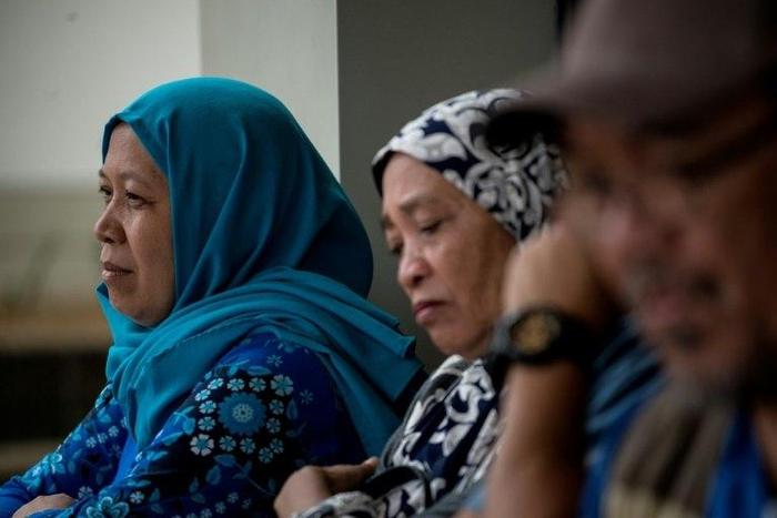 Camalia Baunto (L) waits for news on her husband in Marawi, on the southern Philippine island of Mindanao, on June 15, 2017