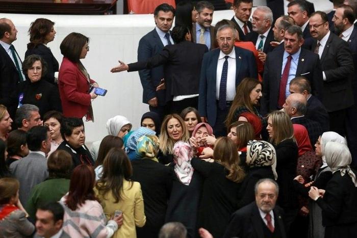 Ruling AK Party and opposition lawmakers scuffle after Turkish deputy Aylin Nazliaka (C) handcuffed herself to the podium in a protest against the constitutional reform aimed at strengthening the powers of the Turkish president on January 19, 2017