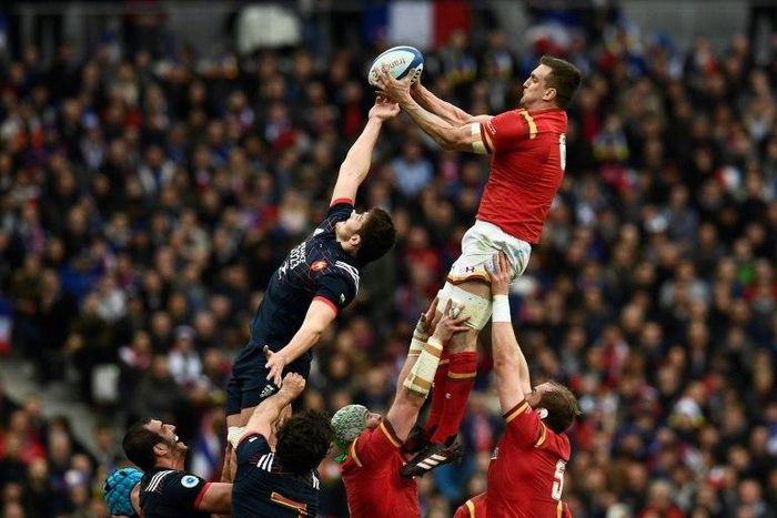 Wales' flanker Sam Warburton (up R) catches the ball in a line-out during the Six Nations tournament Rugby Union match between France and Wales at the Stade de France in Saint-Denis, outside Paris, on March 18, 2017