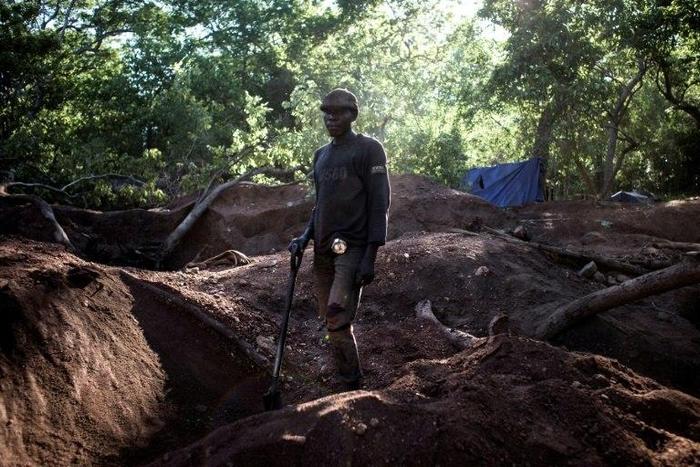 An illegal miner stands in an area rich with gold and rubies on the outskirts of Montepuez, Mozambique