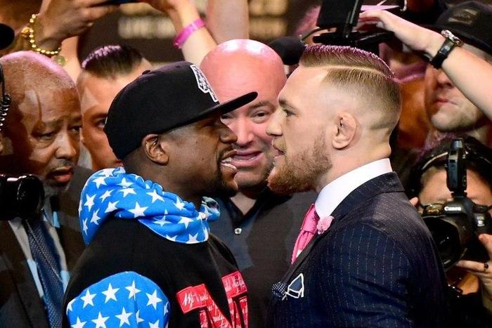 Floyd Mayweather (L) and Conor McGregor stand face to face at the Staples Center on July 11, 2017 in Los Angeles, California