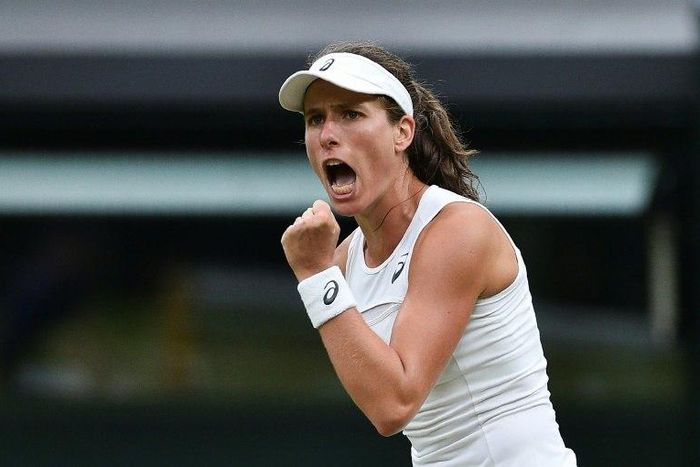 Britain's Johanna Konta reacts afterbeating Romania's Simona Halep at Wimbledon on July 11, 2017