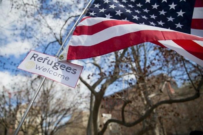 A protester holds a sign near the White House to protest President Donald Trump's travel ban on six Muslim countries on March 11, 2017
