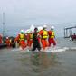 Hundreds of people gathered solemnly on a beach in southern Myanmar awaiting news of their loved ones as rescuers worked to pull bodies from the Andaman Sea after a military plane crashed with more than 120 people on board