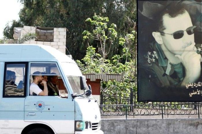 UK Foreign Secretary Boris Johnson said Syrian President Bashar al-Assad (poster R) used chemical weapons because they were "horrible", "indiscriminate" and "terrifying"