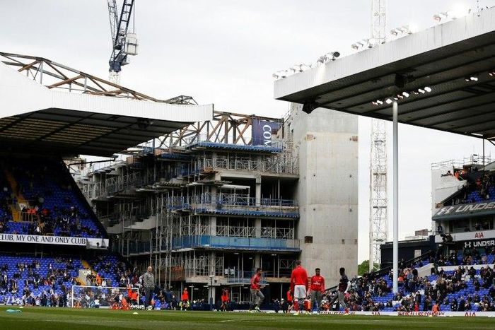 Players warm up with the building works for Tottenham's new stadium in the background at White Hart Lane in northeast London on April 30, 2017