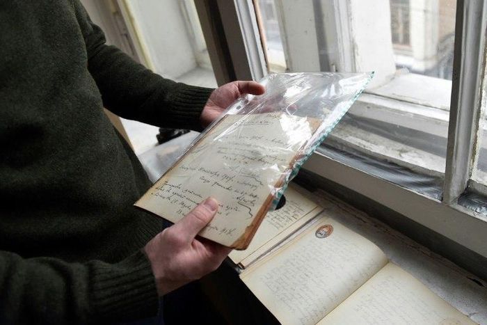 Historian Mikhail Melnichenko holds pages from a Stalin-era diary during an interview with AFP, in Moscow