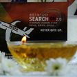 A candle burns a prayer message for passengers of missing Malaysia Airlines flight MH370 in Petaling Jaya on March 8, 2016
