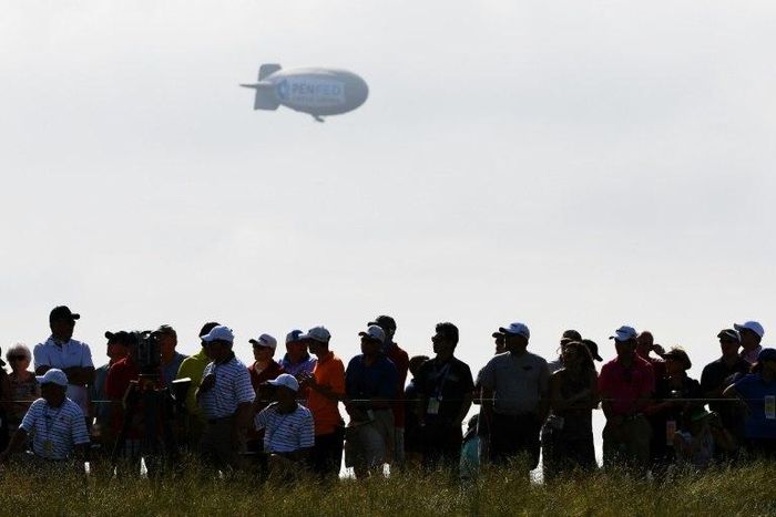 A blimp floats over the crowd during the first round of the 2017 U.S. Open at Erin Hills on June 15, 2017 in Hartford, Wisconsin