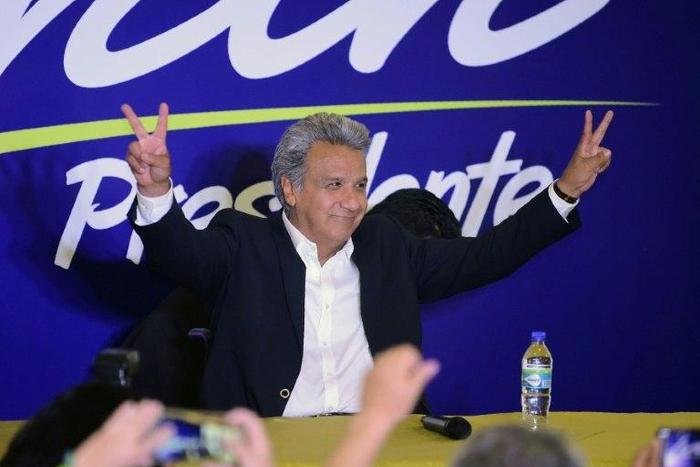 Lenin Moreno, the presidential candidate of the governing Alianza PAIS party, makes the "V for victory" sign to supporters at a hotel in Quito shortly before the results of the country's general elections are announced on February 19, 2017