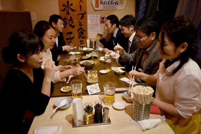 Suntory employees drink at a pub after finishing work at three o'clock in Tokyo, on February 24, 2017
