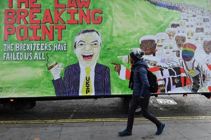 A man walks past a billboard in London depicting former UK Independence party leader Nigel Farage