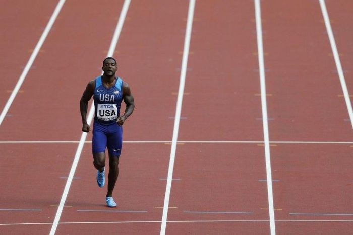 US athlete Justin Gatlin jogs along the track after running his leg in the heats of the men's 4x100m relay athletics event at the 2017 IAAF World Championships at the London Stadium in London on August 12, 2017