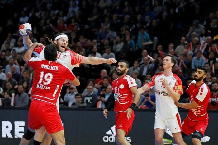 Bahrain's Mohamed Merza Salman (L) defends against Denmark'back Mikkel Hansen during their World Championship match on January 18, 2017 in Paris