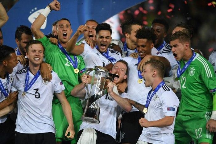 Germany's team celebrate 1-0 victory with the trophy after the UEFA U-21 European Championship football final match Germany v Spain in Krakow, Poland, on June 30, 2017