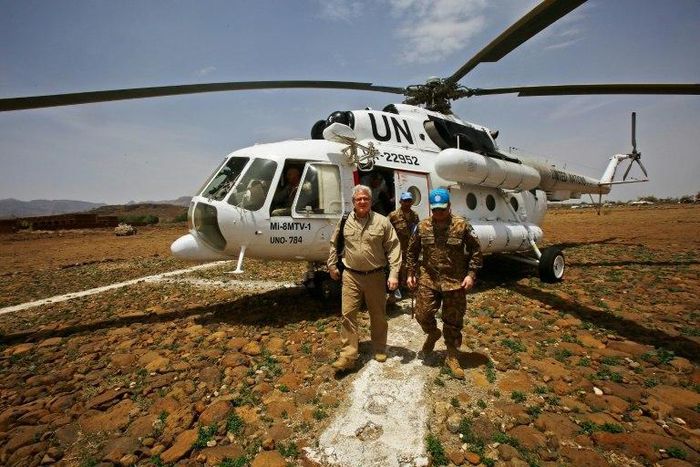 US envoy to Sudan Steven Koutsis (L) disembarks from a UN helicopter after landing in the war-torn town of Golo in the Jebel Marra region of central Darfur on June 19, 2017