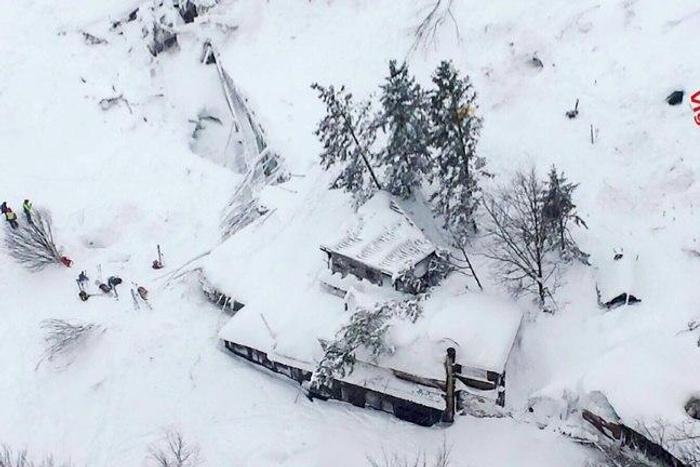 This handout image obtained on the Vigili del Fuoco twitter account on January 19, 2017 shows an aerial view of the Hotel Rigopiano, near the village of Farindola, on the eastern lower slopes of the Gran Sasso mountain, engulfed by a powerful avalanche...