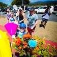 Visitors lay flowers at a makeshift floral tribute at the Dreamworld theme park in Gold Coast on October 26, 2016, a day after four people were killed when a raft flipped at one of the park's attractions