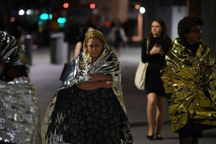 Members of the public, wrapped in emergency blankets, leave the scene of the terror attack on London Bridge in central London on June 3