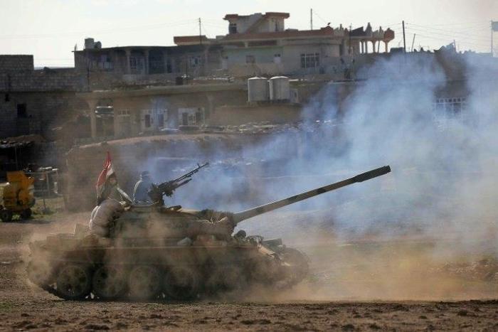 Iraqi government forces supported by fighters from the Abbas Brigade, advance in village of Badush some 15 kilometres northwest of Mosul during the ongoing battle to retake the city's west from Islamic State group March 7, 2017