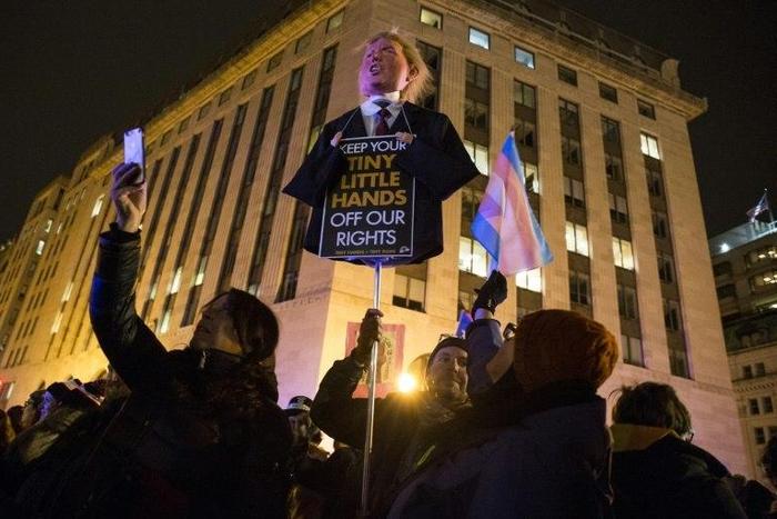 Demonstrators march from the Trump Hotel International Washington to The White House to protest executive orders passed by President Donald Trump