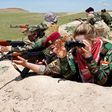 An Iraqi Kurdish female fighter and a Yazidi female fighter aim their weapons near the front line of the fight against ISIS near Mosul, Iraq, April 20, 2016.