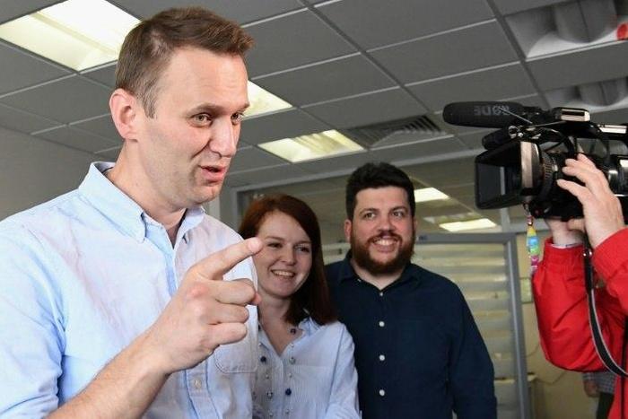Russian opposition leader Alexei Navalny makes a statement for media at his office in Moscow shortly after being released from jail