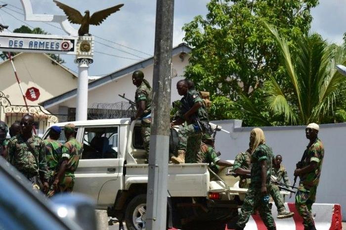 Rebellious soldiers near the entrance of Ivory Coast's army headquarters are demanding the rest of promised back pay