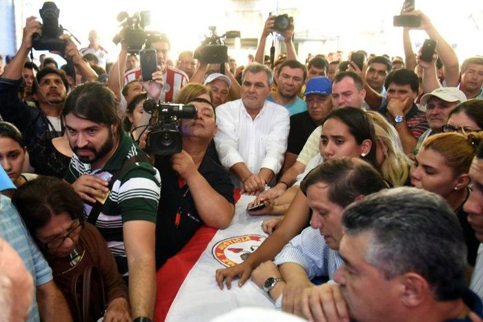 Relatives and friends mourn over the coffin of Rodrigo Quintana, leader of the opposition Liberal Party's youth branch, who was shot dead by police in Asuncion on March 31, 2017