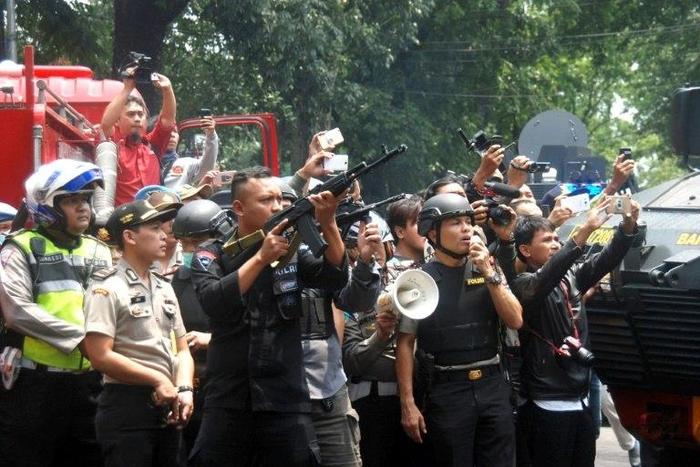 Indonesian police call out to an attacker to surrender during a firefight at a government office in Bandung, February 27, 2017