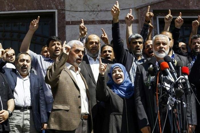 Ismail Haniya (R-2), leader of the Palestinian Islamist movement Hamas, gives a press conference in Gaza City on May 11, 2017, announcing the arrest of the suspected killer of one of its key military commanders, Mazen Faqha
