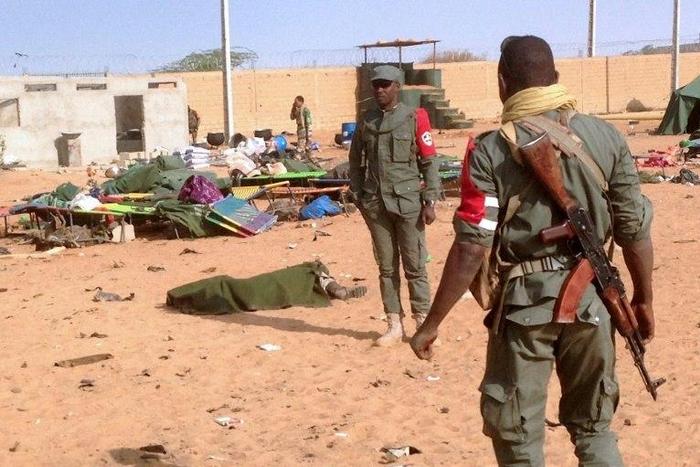 The body of a dead soldier is covered with a blanket after a suicide bomb attack ripped through a camp of former rebels and pro-government militia in northern Mali on January 18, 2017