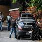 Venezuelan intelligence service members stand guard outside the home of ousted attorney general Luisa Ortega, who says it was raided and searched