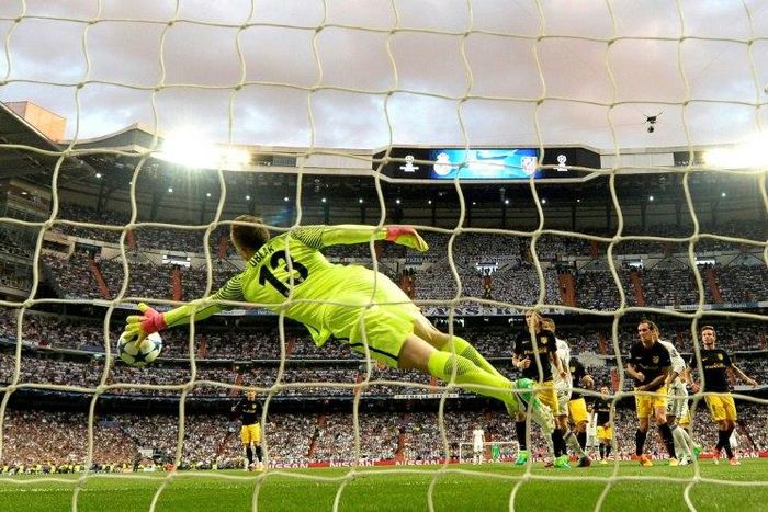 Atletico Madrid's goalkeeper Jan Oblak stops the ball during their UEFA Champions League semi-final 1st leg match against Real Madrid, at the Santiago Bernabeu stadium in Madrid, on May 2, 2017