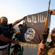 Iraqi Shiite militia fighters hold the Islamic State flag as they celebrate after breaking the siege of Amerli by Islamic State militants.