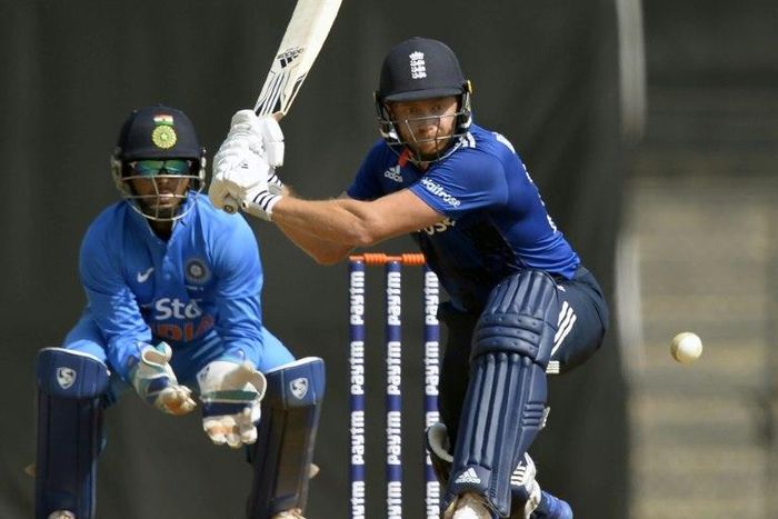 England player Jonny Bairstow (R) makes a mark both in front of and behind the wicket