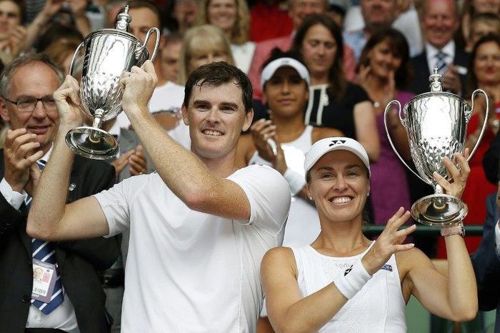Britain's Jamie Murray (L) and Switzerland's Martina Hingis hold their trophies after beating Finland's Henri Kontinen and Britian's Heather Watson during the mixed doubles final at Wimbledon