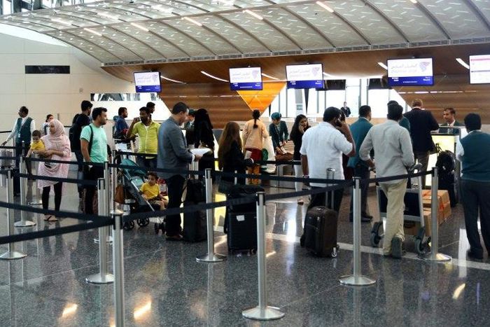 Passengers wait to check-in at the Hamad International Airport in Doha on June 7, 2017 after a ban on Qatari flights imposed by Saudi Arabia and its allies which cut ties with Doha and ordered Qataris out