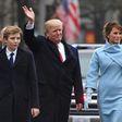 US President Donald Trump and First Lady Melania Trump walk the inaugural parade route with son Barron on Pennsylvania Avenue in Washington, DC