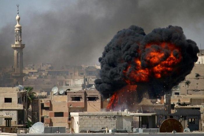 A ball of fire rises from a building following a reported air strike on June 11, 2017 by Syrian forces on a rebel-held area in the southern city of Daraa, which was among areas where a ceasefire took effect on Sunday