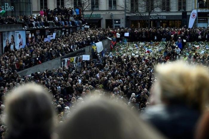 People attend a memorial ceremony on April 9, 2017 at Sergels Torg plaza in Stockholm, Sweden, close to the point where a truck drove into a department store two days before
