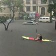 An expat seen paddling a canoe in flooded Victoria Island.