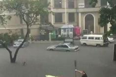 An expat seen paddling a canoe in flooded Victoria Island.