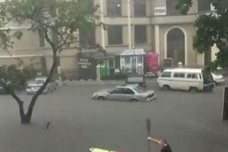 An expat seen paddling a canoe in flooded Victoria Island.