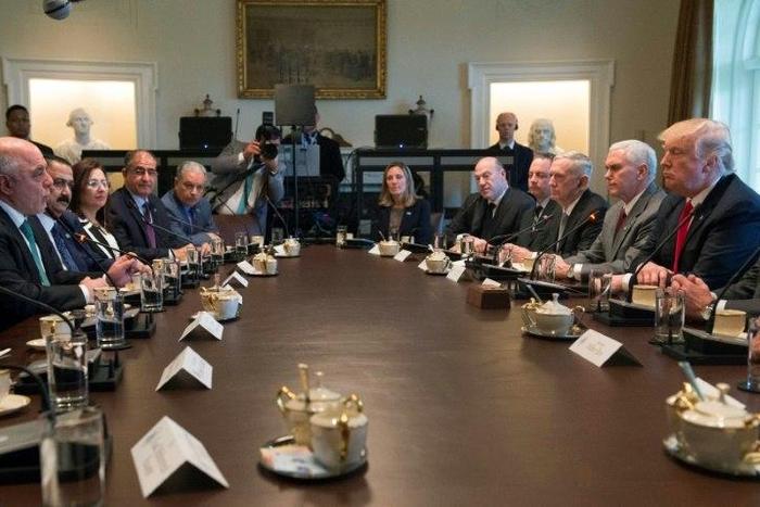 US President Donald Trump listens while Iraqi Prime Minister Haider Al-Abadi speaks during their meeting in the Cabinet Room in the White House on March 20, 2017