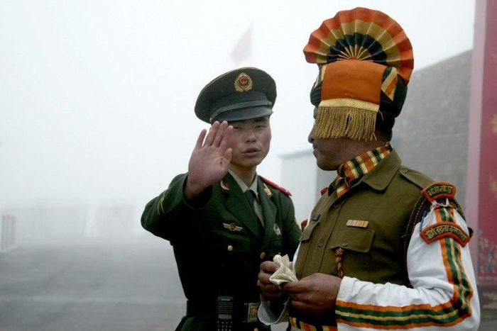 Chinese and Indian soldiers stand guard at the Nathu La border crossing in India's northeastern Sikkim state, near the disputed Doklam territory