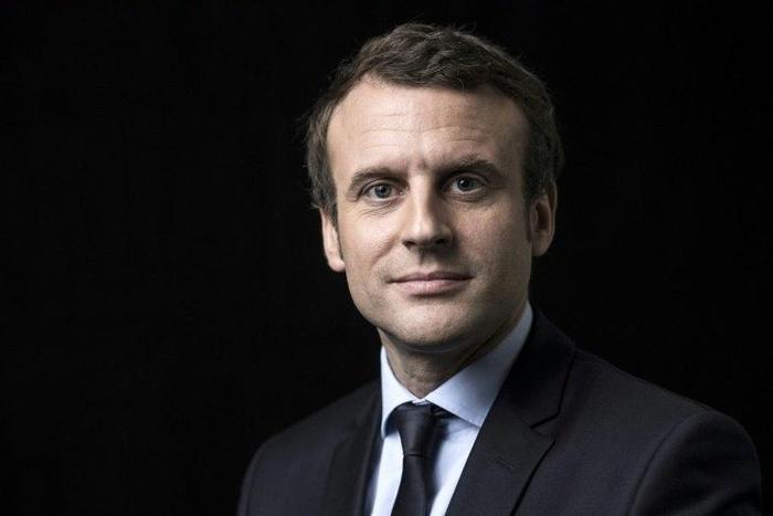 French presidential election candidate for the En Marche movement Emmanuel Macron poses for a photo session on March 7, 2017 at his campaign headquarters in Paris