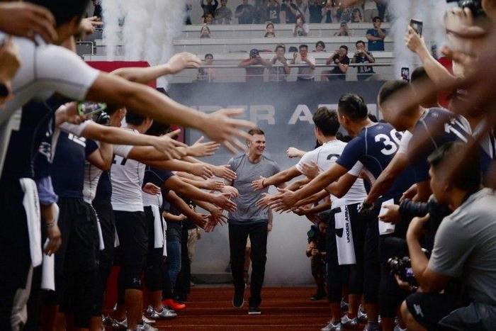 US New England Patriots quarterback Tom Brady takes to the field during a promotional event in Shanghai on June 20, 2017