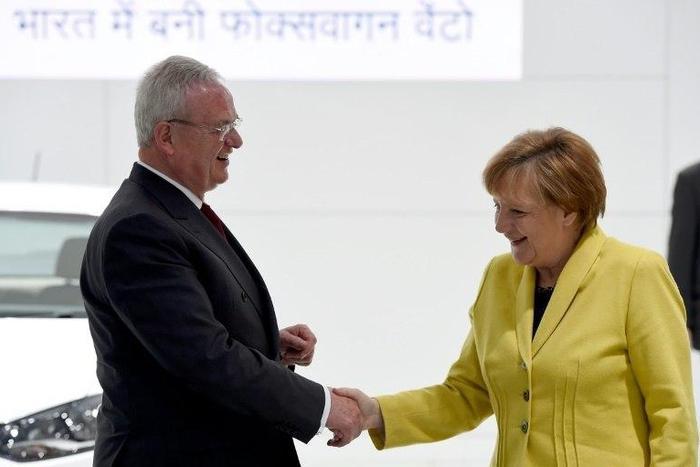 German lawmakers will be asking Chancellor Angela Merkel, pictured here with Volkswagen's then-CEO Martin Winterkorn in April 2015, about the extent of her government's support for the carmaker