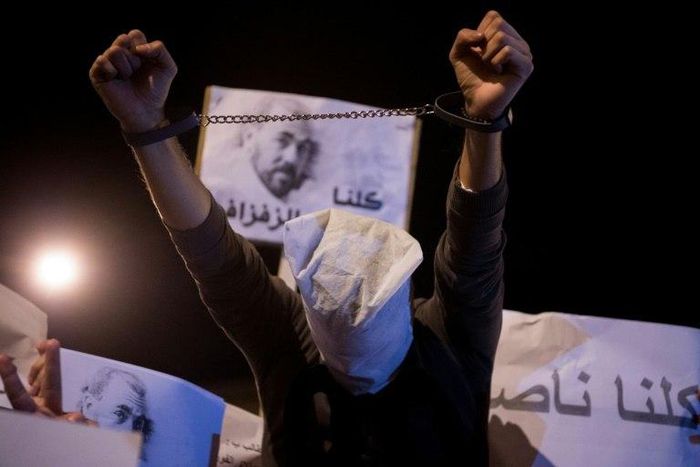 Demonstrators in Morocco's neglected northern Rif region hold pictures of arrested protest leader Nasser Zafzafi during a night-time rally in the city of Al-Hoceima on May 30, 2017